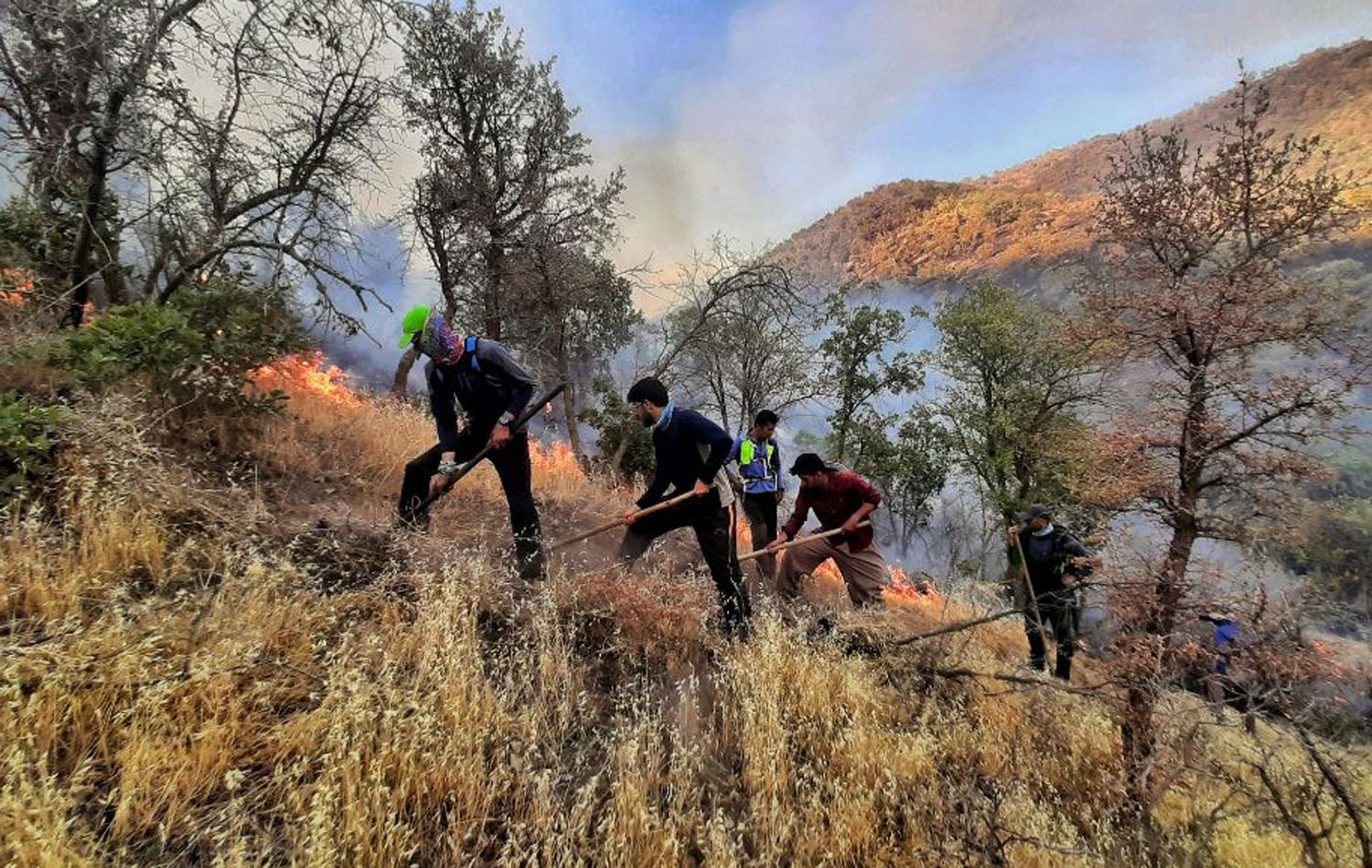 Landmines, wind, scorpions: Firefighters battle hazards to extinguish the flames